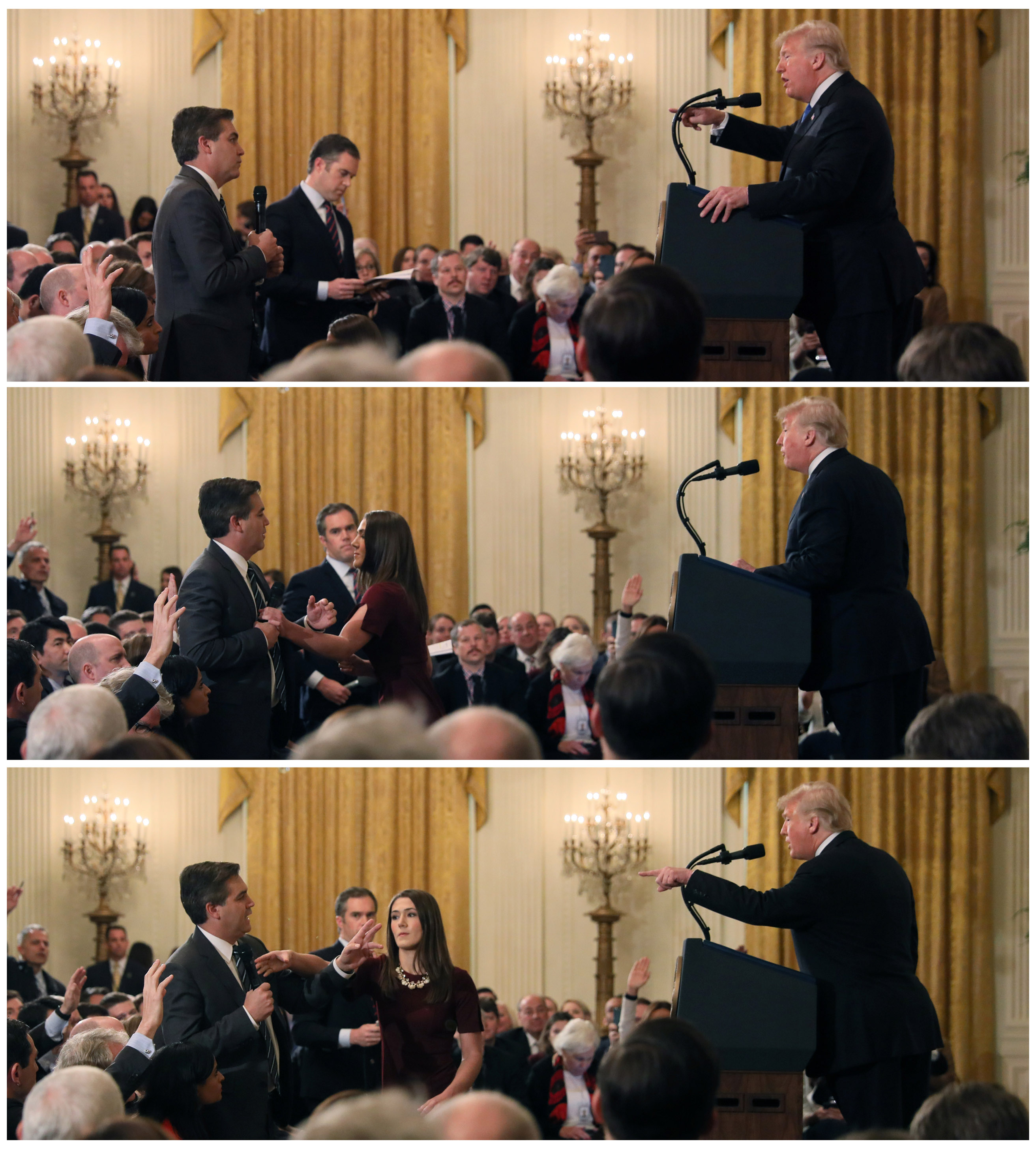 Seorang anggota staf Gedung Putih berusaha meraih mikrofon yang dipegang Jim Acosta dari CNN saat dia bertanya kepada Presiden AS Donald Trump. (Foto: Reuters/Al Jazeera)