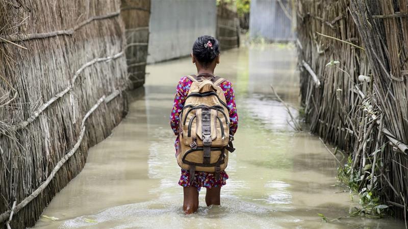 Seorang anak melintasi air (baanjir) dalam perjalanannya ke sekolah di distrik Kurigram, Bangladesh utara saat banjir pada Agustus 2016. (Foto: File Unicef/Al Jazeera)