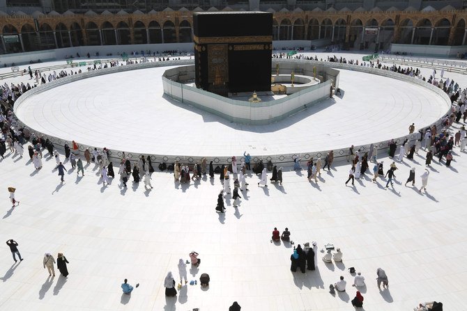 Para jemaah mengelilingi Ka'bah di Masjidil Haram Makkah. Sejak beberapa waktu lalu hingga Senin (9/3) jemaah tidak diperkenankan melakukan tawaf berdekatan langsung dengan Ka'bah, karena dalam upaya memerangi wabah koronavirus dilakukan sterilisasi dengan memagari Ka’bah dalam jarak tertentu sepperti terlihat pada gambar. (Foto: AFP/Al Jazeera)